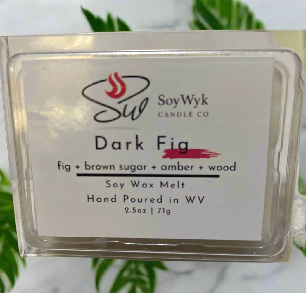 White Soy Wax Melt in a 2.5 oz clear package. Wax Melt on white counter with green plants behind them. Labeled as “Dark Fig”. Featured fragrant notes are fig, brown sugar, amber, woods. 
Hand-poured in WV by SoyWyk Candle Co. 