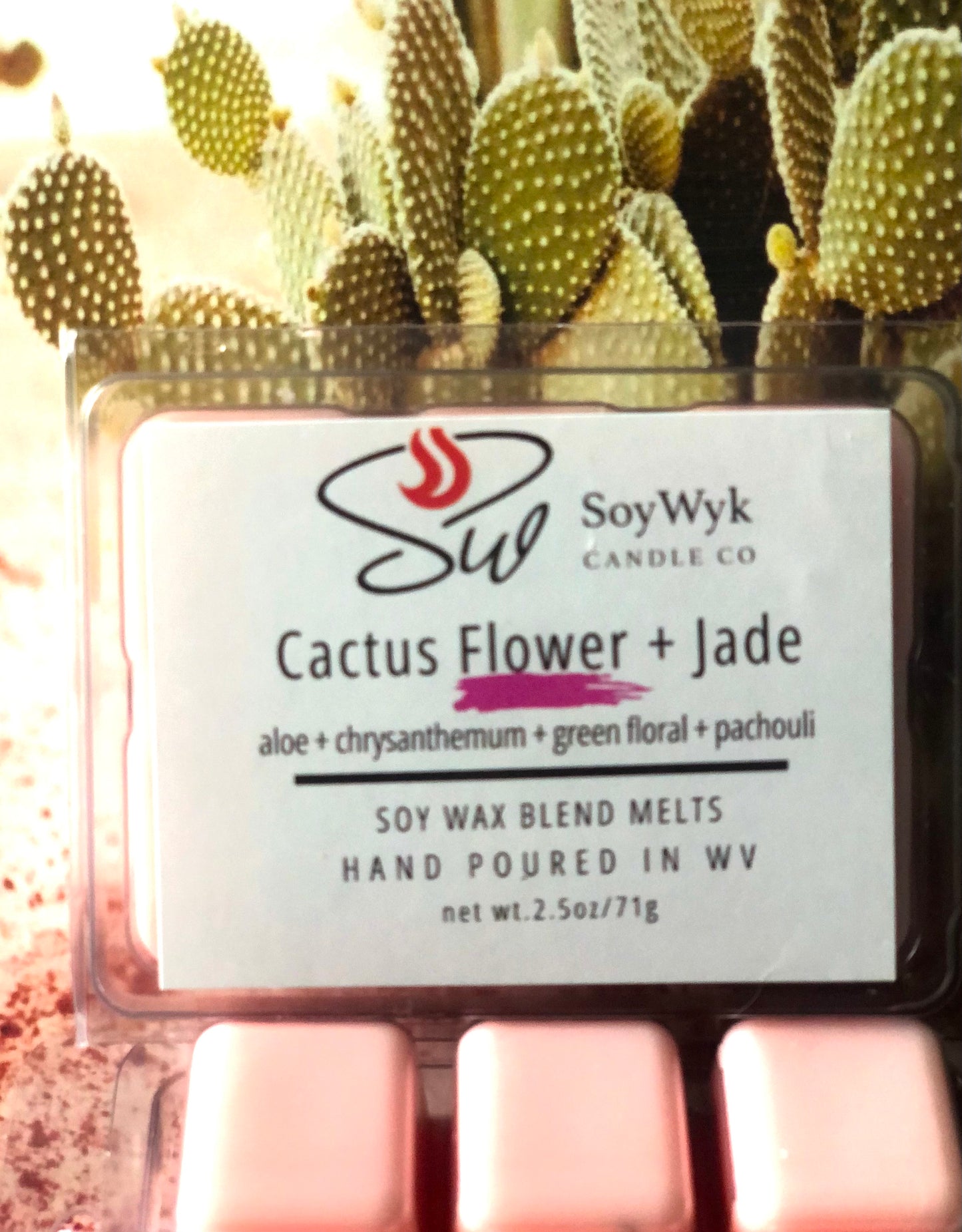 Light peach Soy wax melt in 2.5 oz clear package labeled “Cactus Flower & Jade” with a background outside in the desert with a large cactus behind the wax melt. Featured fragrant notes are  aloe, chrysanthemum, green floral, patchouli. Hand- poured in WV by SoyWyk Candle Co. 