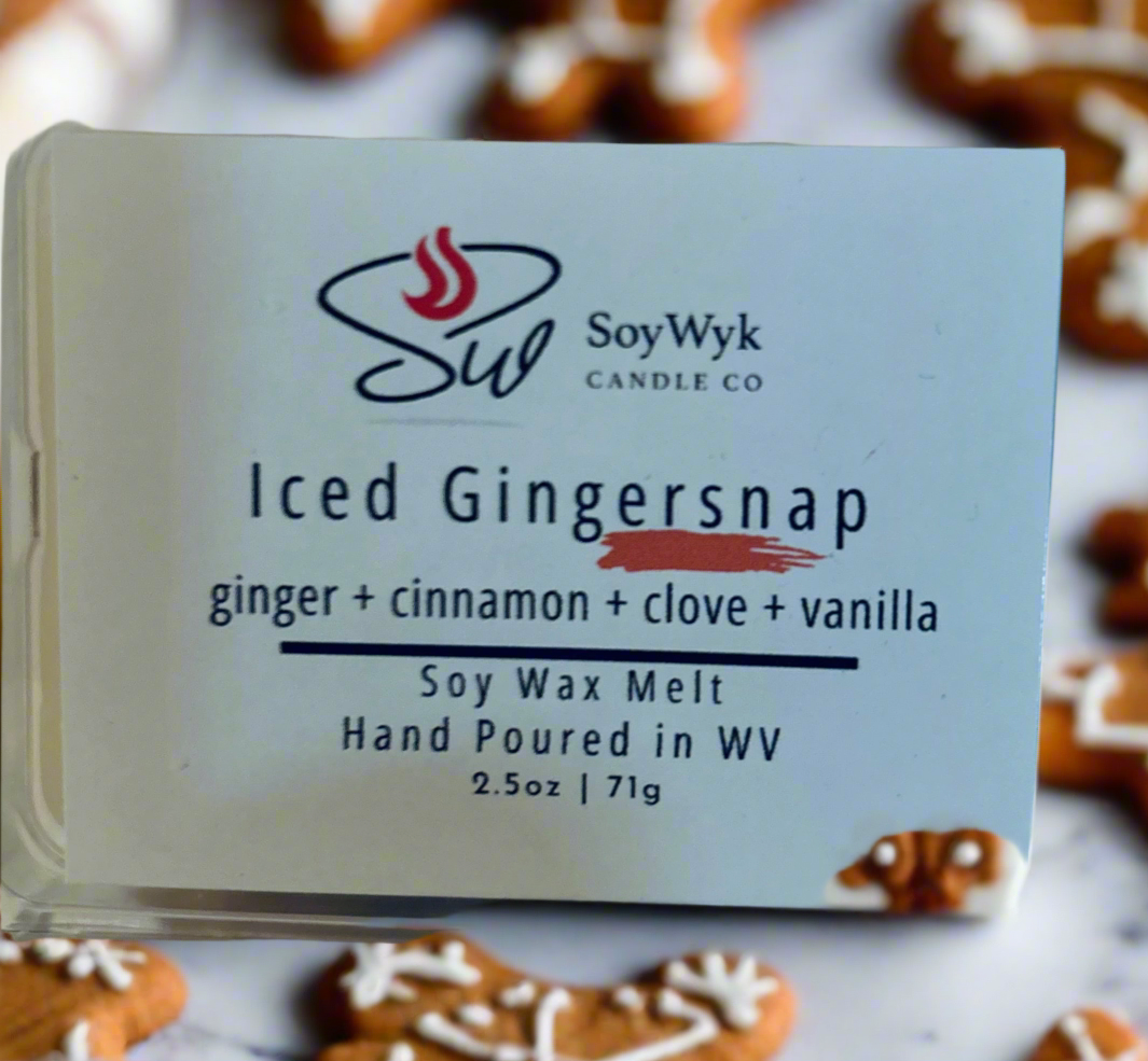 White Soy wax melt 2.5 oz clear package labeled “Iced Gingersnap”. Featured fragrant notes are ginger, cinnamon, clove,  and vanilla. On a white surface surrounded by gingerbread men cookies. Hand poured by SoyWyk Candle Co in WV. 