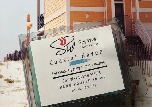 
Teal Soy Wax Melt in a 2.5 oz clear package along the coast of the beach in front of a light melon colored beach house. Labeled as “Costal Haven. Featured fragrant notes are bergamot, peony, mint, marine notes. 
Hand-poured in WV by SoyWyk Candle Co. 