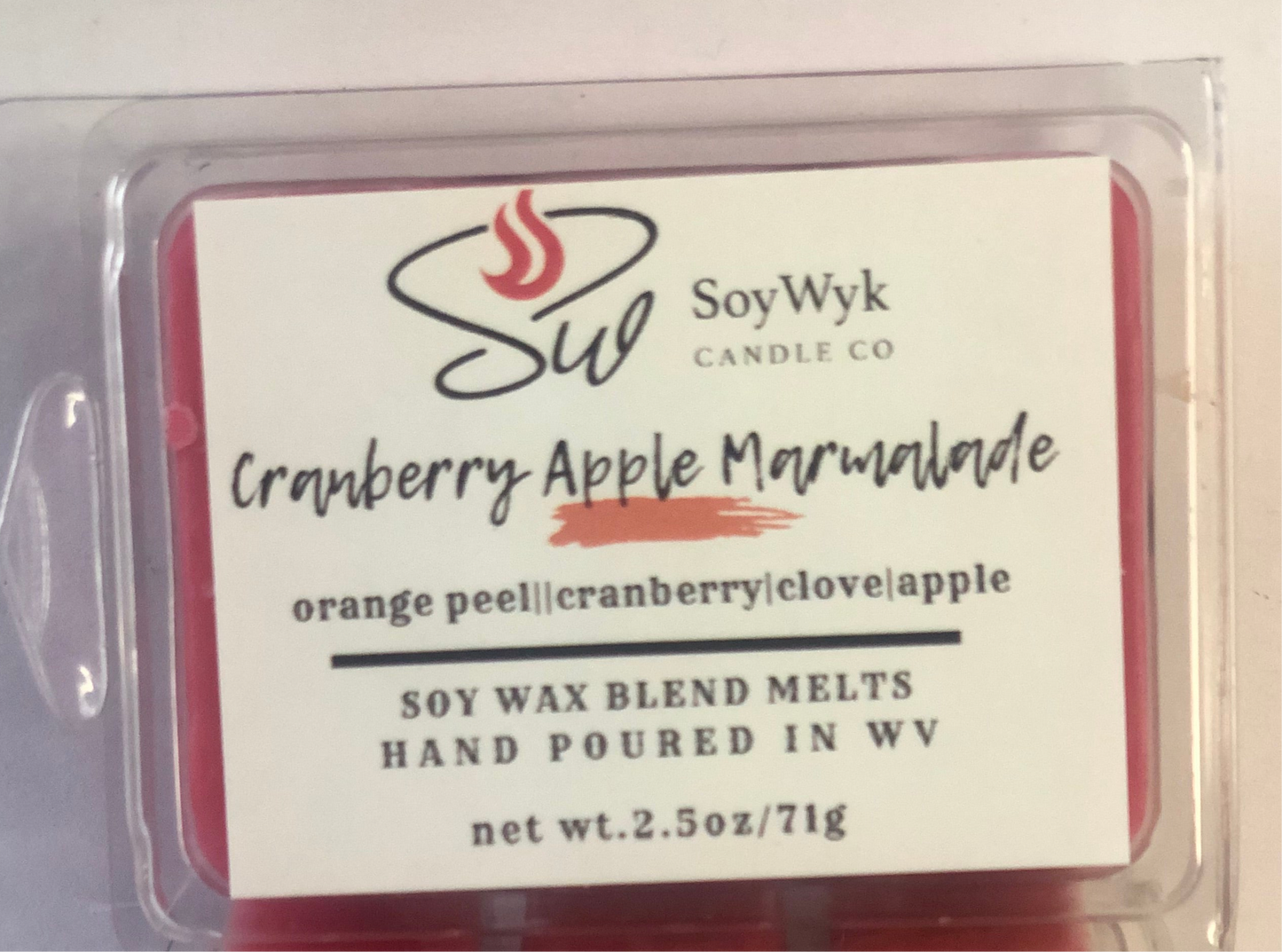 White Soy Wax Melt in a 2.5 oz clear package.  Wax melt on a white ceramic countertop in a modern kitchen few apples in view. Labeled as “Cranberry Apple Marmalade “.
Featured fragrant notes are orange peel, cranberry, apple, clove. 
Hand-poured in WV by SoyWyk Candle Co. 